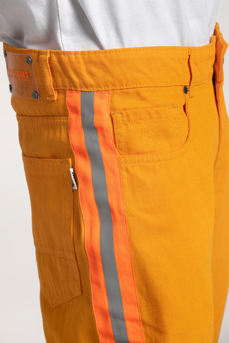Overdyed orange color denim with reflective tape on both sides.